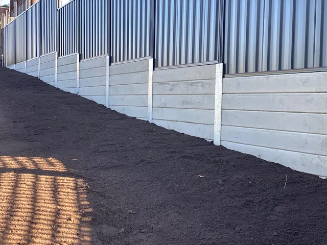 White concrete sleeper retaining wall stepping down a newly levelled yard
